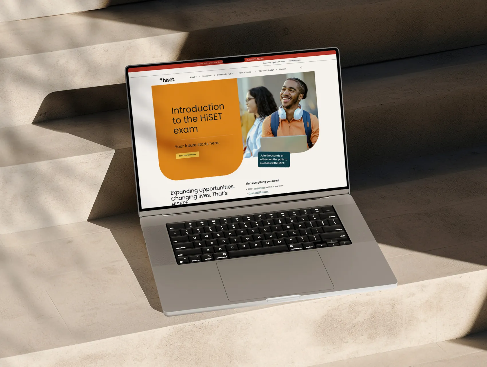 HiSET client work — laptop on stone steps